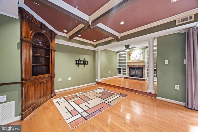 unfurnished living room with visible vents, coffered ceiling, and ornate columns