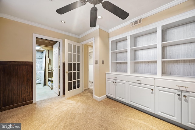 interior space featuring a ceiling fan, visible vents, recessed lighting, crown molding, and light colored carpet