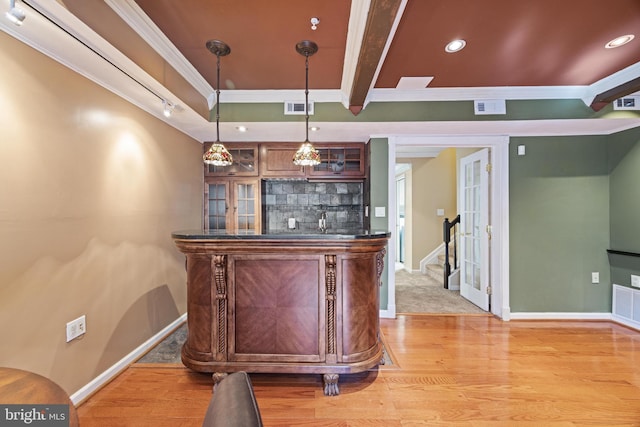 bar featuring visible vents, backsplash, baseboards, beamed ceiling, and light wood-type flooring