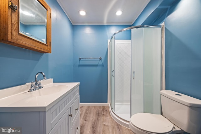 full bath with vanity, toilet, wood finished floors, and a stall shower