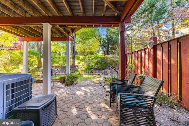 view of patio with a jacuzzi and cooling unit