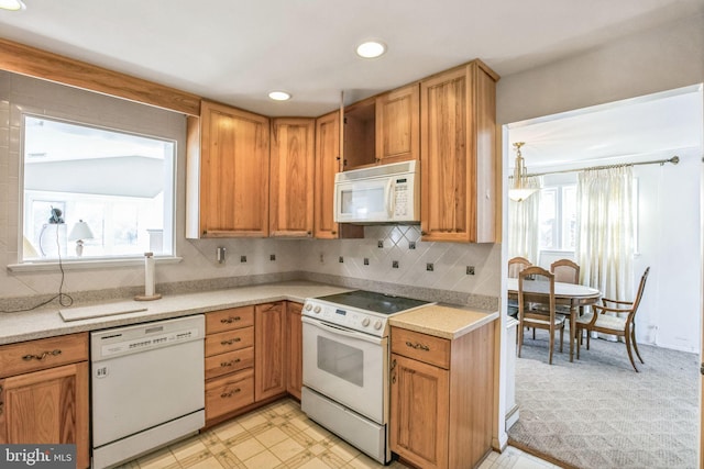 kitchen with white appliances and decorative backsplash