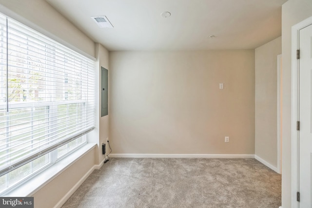 carpeted empty room featuring electric panel