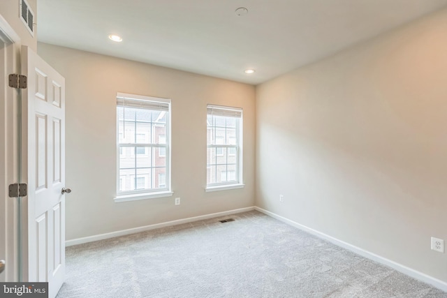 spare room with light colored carpet