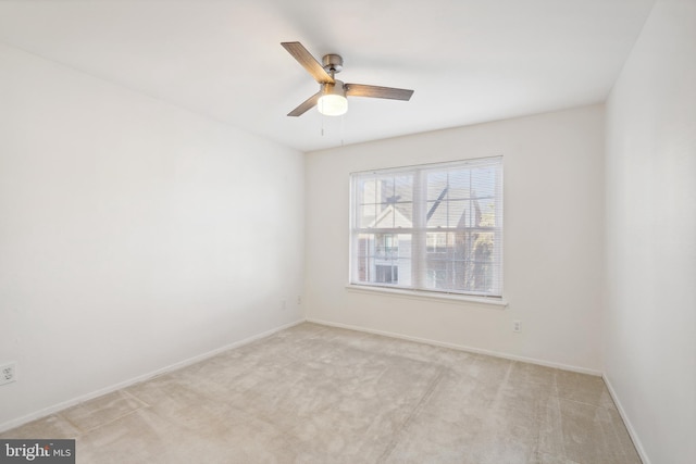 unfurnished room featuring light colored carpet and ceiling fan