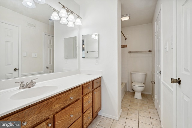 full bathroom featuring tiled shower / bath combo, vanity, tile patterned floors, and toilet