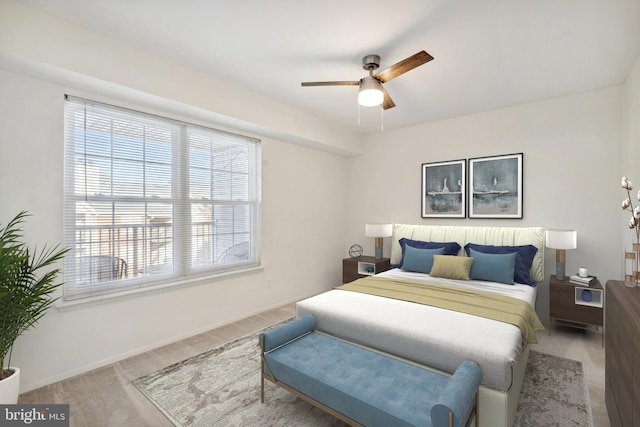 bedroom featuring ceiling fan and light carpet