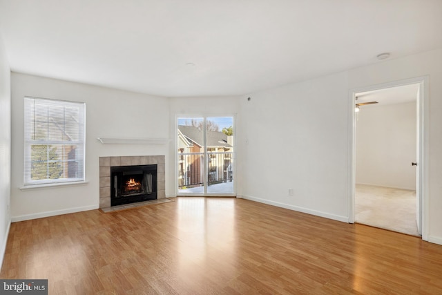 unfurnished living room featuring a fireplace and light hardwood / wood-style floors