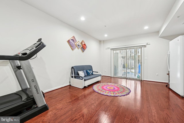 exercise room with dark wood-type flooring