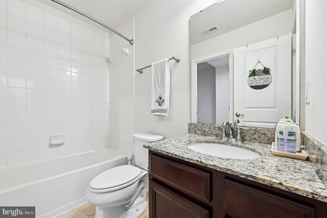 full bathroom with tiled shower / bath, vanity, toilet, and tile patterned floors