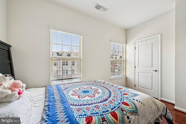 bedroom with dark wood-type flooring