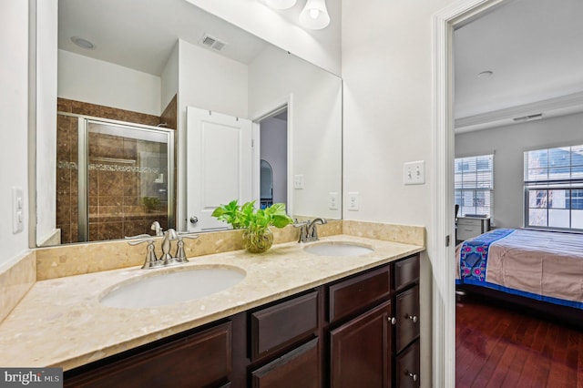 bathroom featuring vanity, wood-type flooring, and an enclosed shower