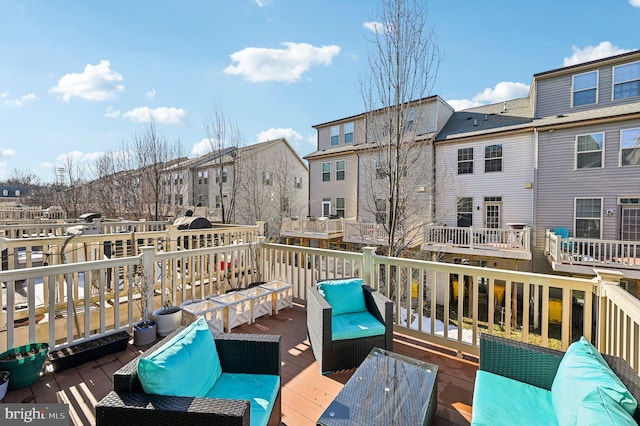 wooden balcony with a wooden deck and an outdoor hangout area