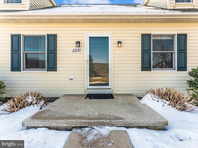 view of snow covered property entrance