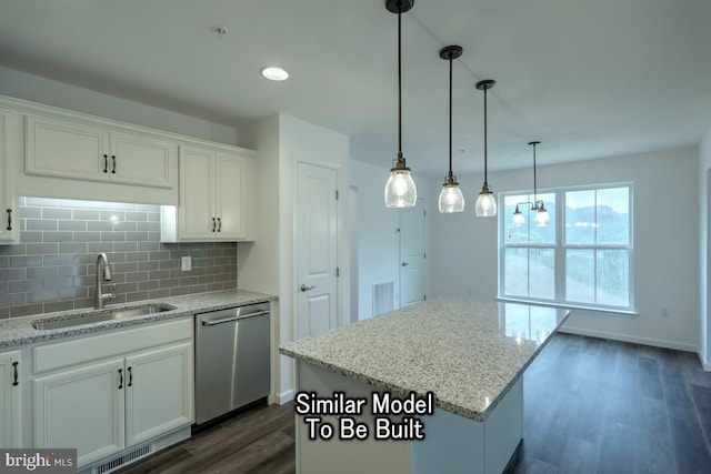 kitchen with sink, dishwasher, tasteful backsplash, white cabinets, and a kitchen island