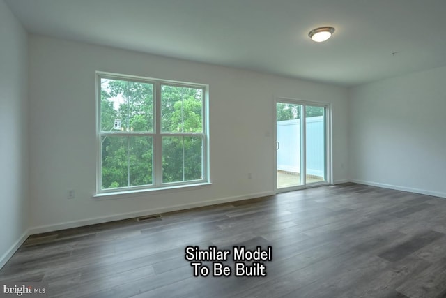 unfurnished room with dark wood-type flooring