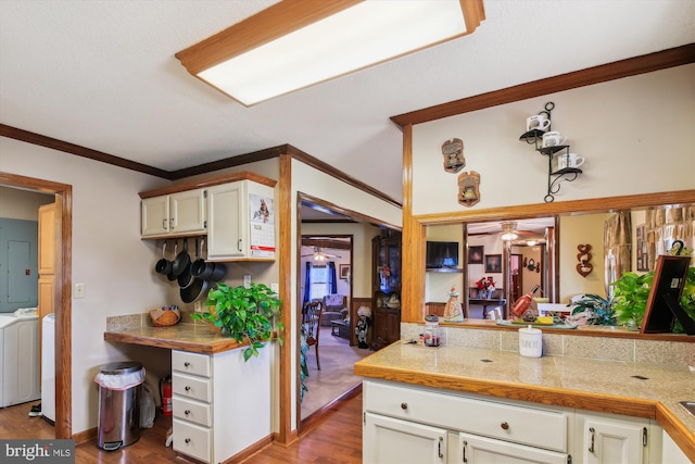 kitchen featuring crown molding, separate washer and dryer, ceiling fan, and light hardwood / wood-style flooring