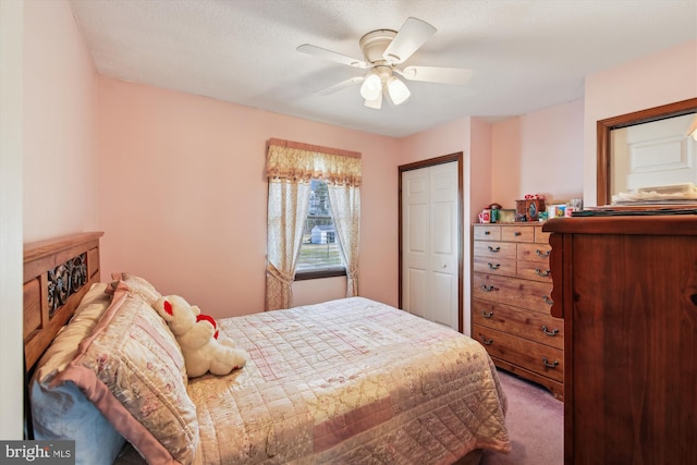 carpeted bedroom featuring ceiling fan and a closet