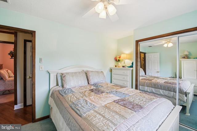 bedroom with ceiling fan and dark carpet