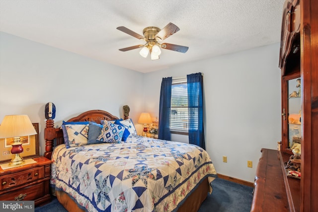 bedroom with ceiling fan and a textured ceiling