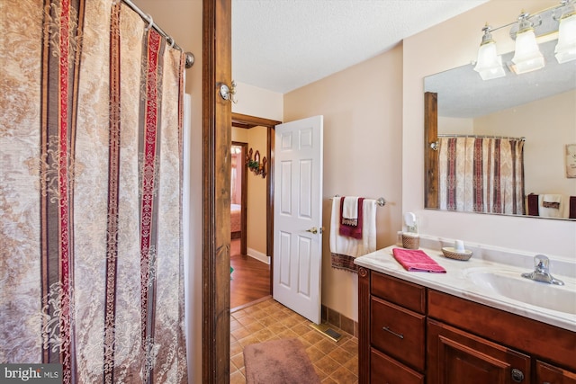 bathroom featuring vanity and a textured ceiling