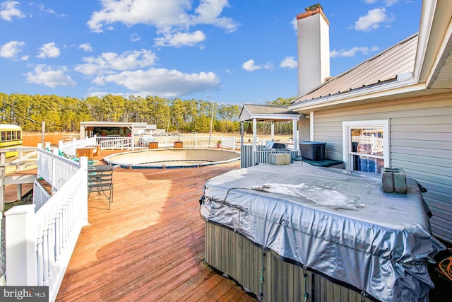 deck with a pool with hot tub