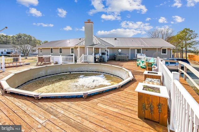 view of pool featuring a wooden deck and a jacuzzi