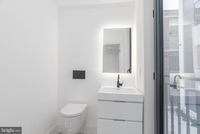 bathroom featuring vanity and toilet