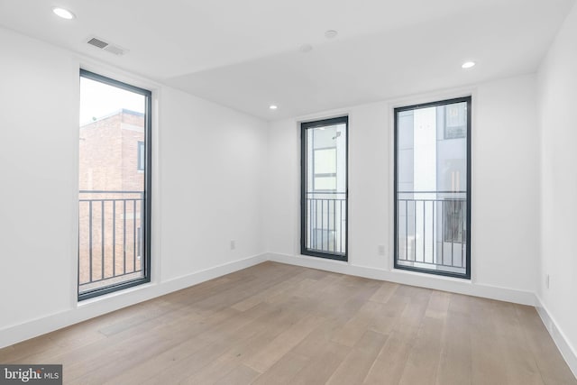 spare room with light hardwood / wood-style flooring