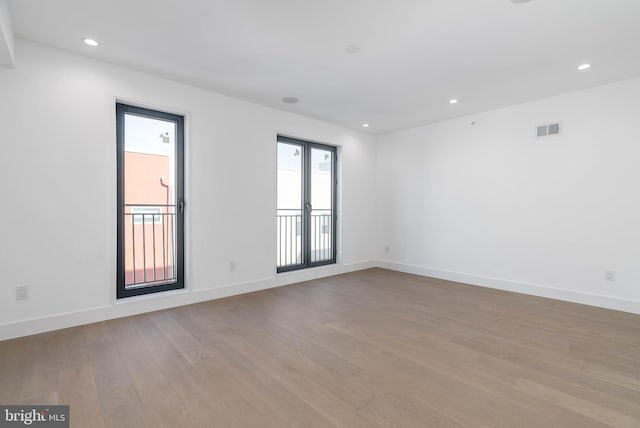 unfurnished room with light wood-type flooring