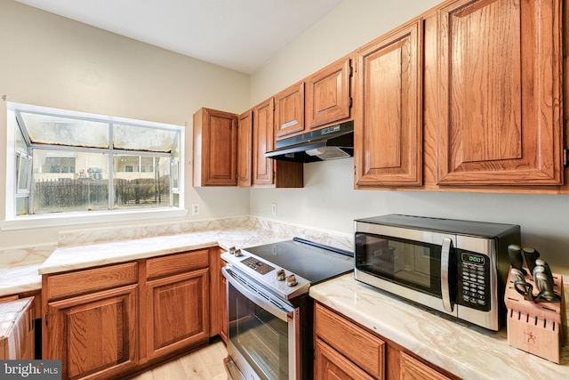 kitchen with appliances with stainless steel finishes and light wood-type flooring