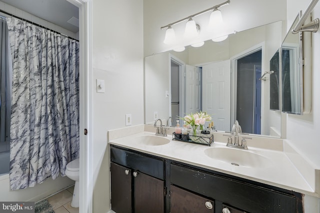 full bathroom with tile patterned flooring, vanity, shower / bath combo with shower curtain, and toilet