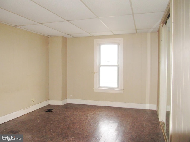 spare room with a drop ceiling