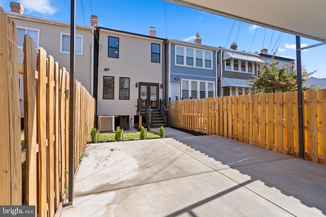 rear view of property with a patio area and central air condition unit