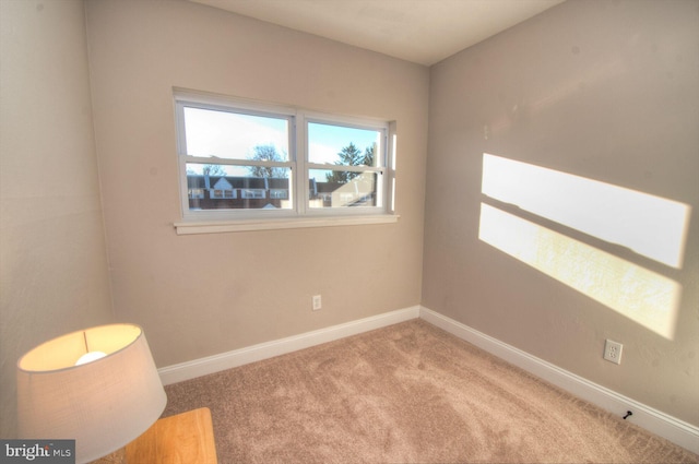 unfurnished room with light carpet