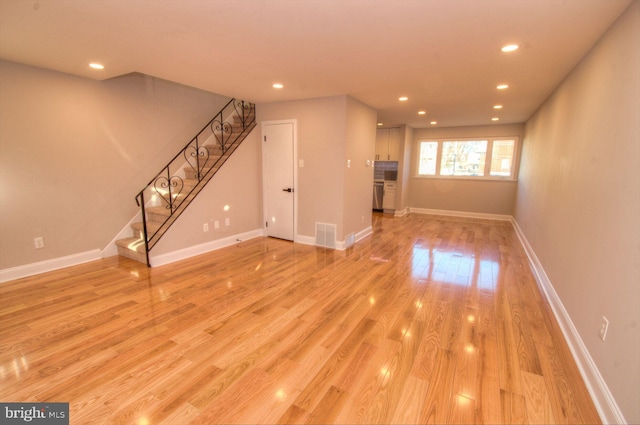 unfurnished living room with light wood-type flooring