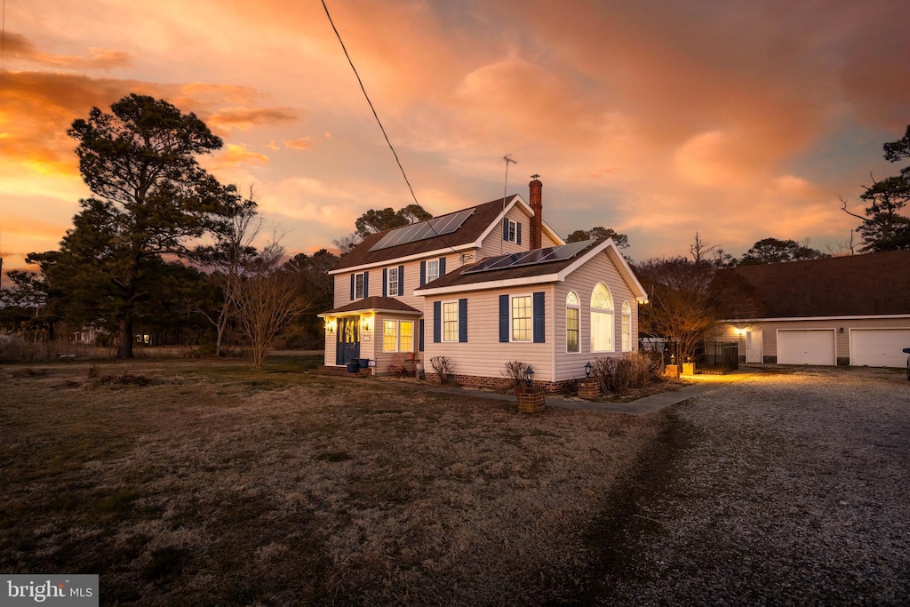 view of front of house with a garage and solar panels