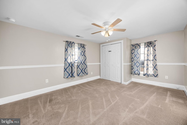 unfurnished room featuring carpet flooring and ceiling fan