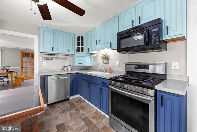 kitchen featuring blue cabinetry, ceiling fan, stainless steel appliances, and sink