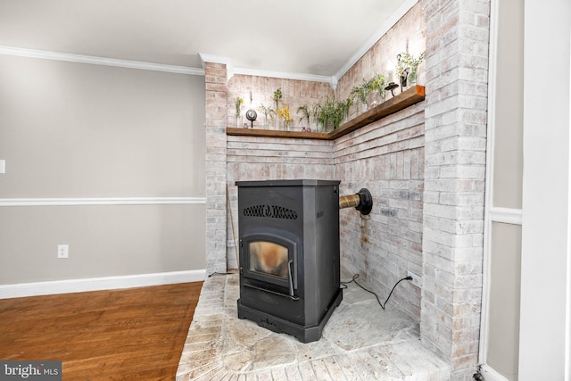 room details with crown molding, hardwood / wood-style flooring, and a wood stove