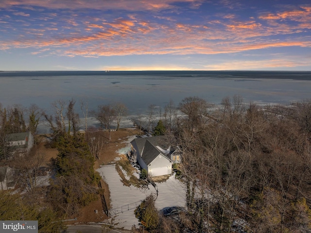 aerial view at dusk with a water view