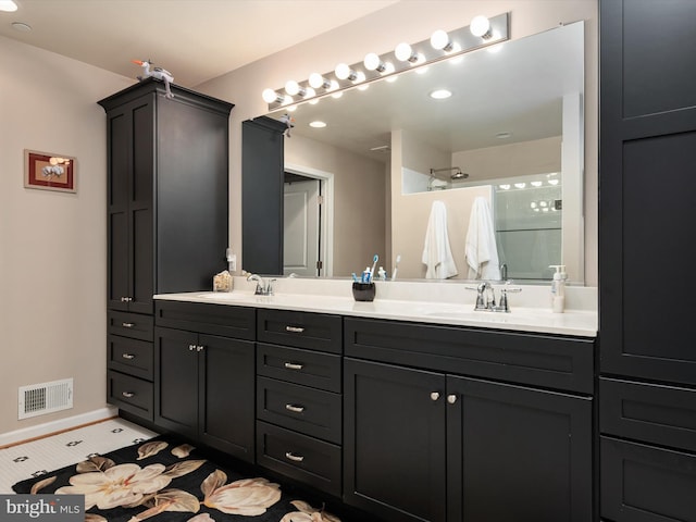 bathroom with vanity and a shower with shower door