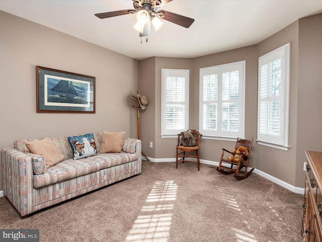 carpeted living room featuring ceiling fan