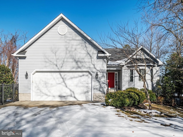 snow covered property with a garage