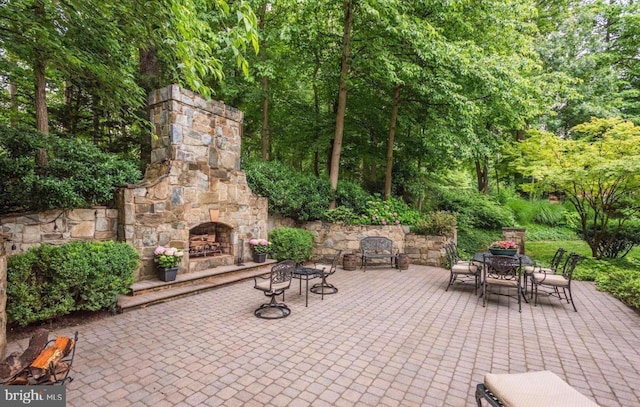 view of patio with an outdoor stone fireplace