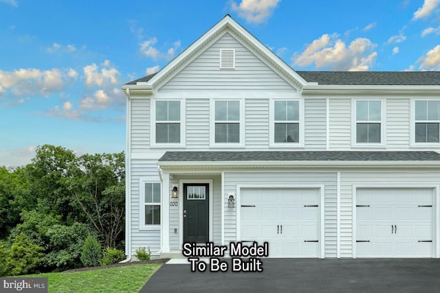 view of front facade featuring a garage, roof with shingles, and driveway