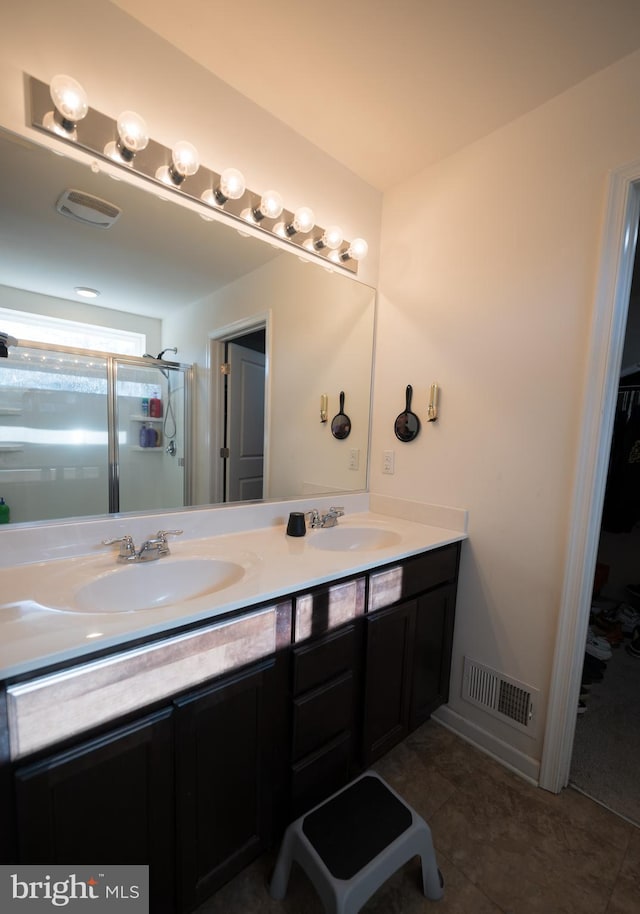 bathroom featuring vanity, tile patterned floors, and walk in shower