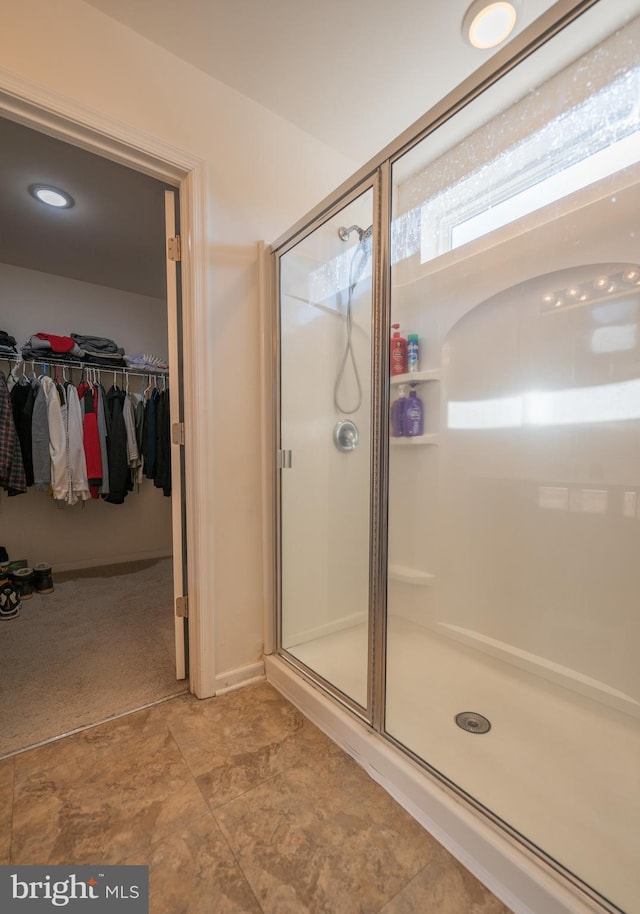 bathroom with a shower with door