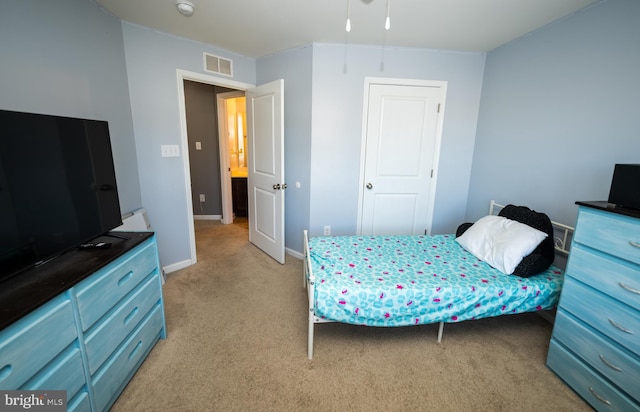 bedroom featuring light colored carpet