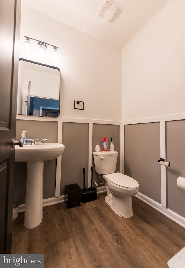 bathroom with wood-type flooring and toilet